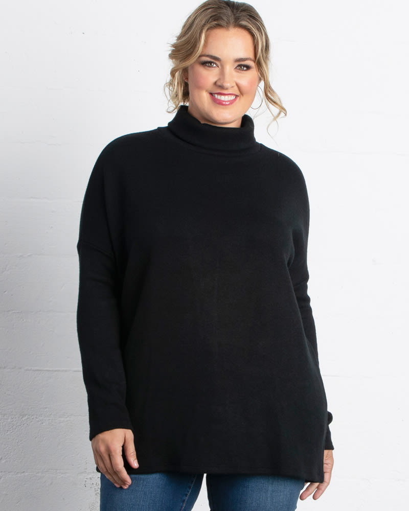 Front of a model wearing a size 0X Paris Turtleneck Tunic Sweater in BLACK NOIR by Kiyonna. | dia_product_style_image_id:227430